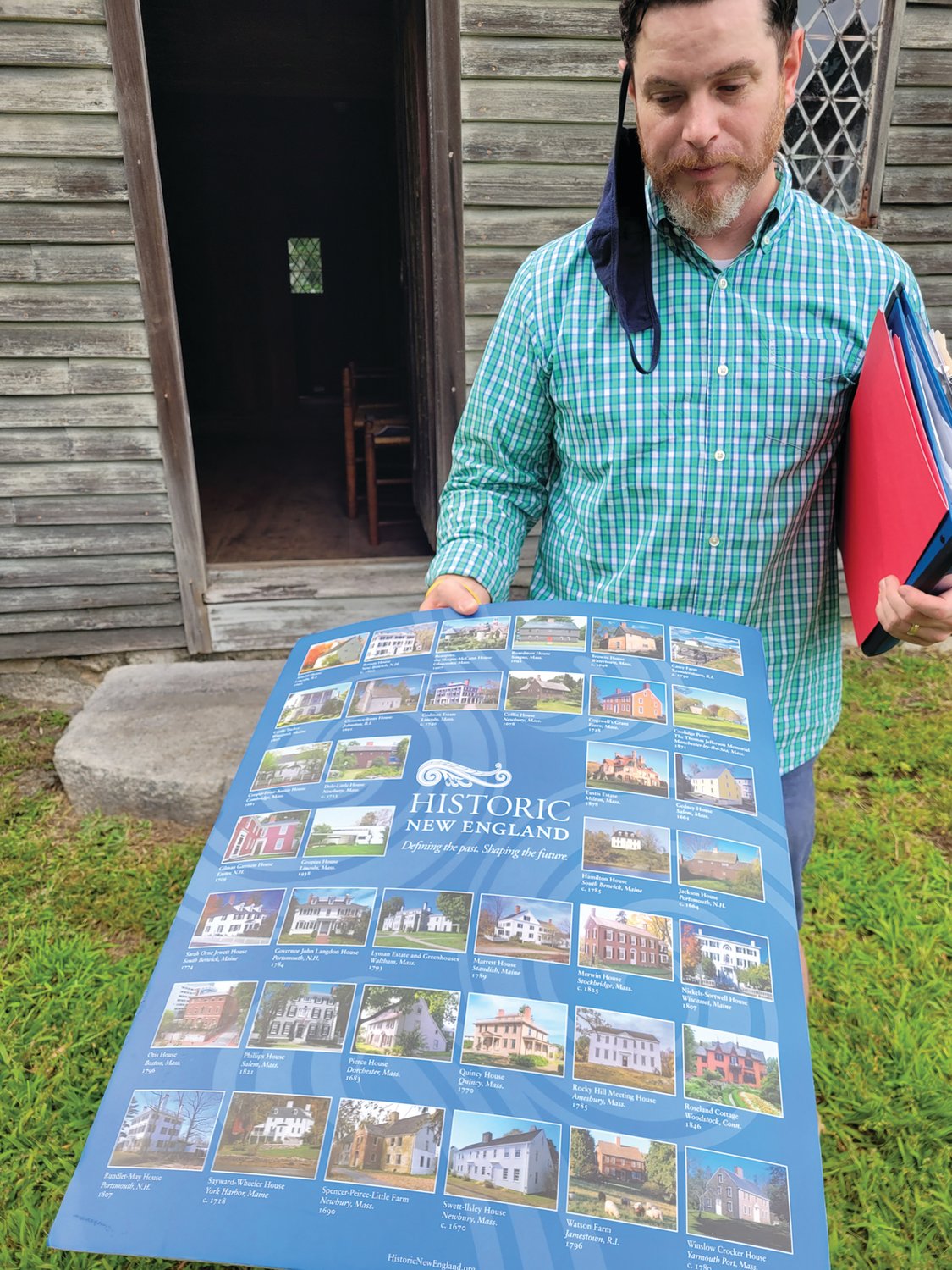 SPREADING IMPACT: Historic New England representative Dan Santos, regional site administrator for Southern New England, holds a poster showing all of the organizations house museums and preserved homesteads. Some of the locations are currently open for tours, but some are not, due to the COVID-19 pandemic.